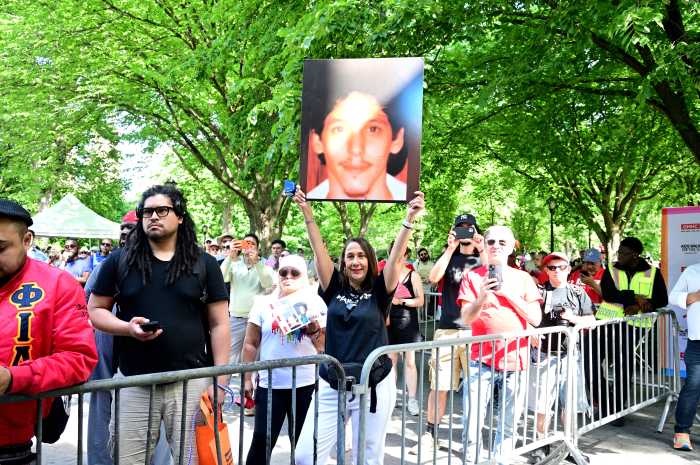 A walker at AIDS Walk New York holds a picture of their late brother.