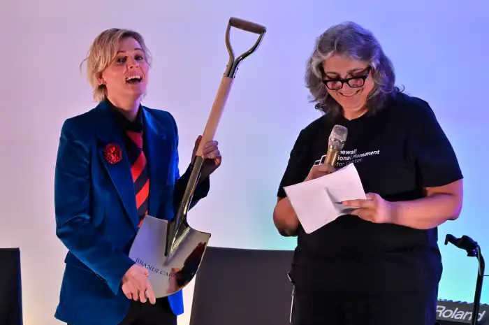 Diana Rodriguez presents Brandi Carlile with a shovel featuring her name.